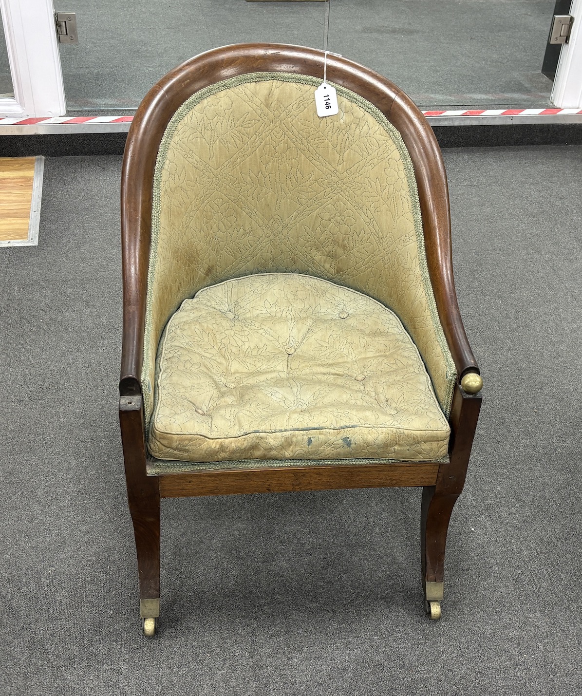 A 19th century Gillows style mahogany armchair on sabre legs width 54cm, depth 64cm, height 76cm.